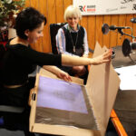 Dotora Tworek, członek zarządu firmy Dorbud podarowała kalendarz firmy Dorbud zawierający prace malarskie autorstwa Jakuba Ciężkiego. / Wojciech Habdas / Radio Kielce