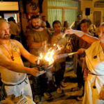 11.08.2017 Nowa Słupia. Dyrektor biura Zarządu Regionalnej Organizacji Turystycznej Województwa Świętokrzyskiego Małgorzata Wilk - Grzywna odpala pochodnię przed uroczystym przemarszem Korowodu / Marzena Mąkosa - Radio Kielce / Nowa Słupia. Uroczysty Korowód z Pochodniami z okazji 51. Dymarek Świętokrzyskich.