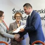 Wręczenie rządowej promesy i podpisanie umów na remonty i budowy dróg gminnych. Agata Wojtyszek - wojewoda świętokrzyski i Maria Zuba - poseł PiS wręczają promesę / Marzena Mąkosa / Radio Kielce