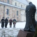 20.01.2022. Kielce. Złożenie kwiatów pod pomnikiem biskupa Czesława Kaczmarka. Na zdjęciu (od lewej): ks. Marcin Polak - wikariusz, ks. kan. dr Mirosław Cisowski - rzecznik kurii, Krzysztof Słoń - senator, Rafał Nowak - wicewojewoda świętokrzyski / Wiktor Taszłow / Radio Kielce