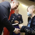 14.01.2022 Kielce. ŚUW. Finał konkursu "Pie(rw)szy na przejściu". Wojewoda Zbigniew Koniusz i nadinsp. Jarosław Kaleta wręczają dyplom dla Jakuba Chmielewskiego / Jarosław Kubalski / Radio Kielce