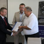 04.08.2022. Tuczępy. Podpisanie umowy z wykonawcą 2-kilometrowego odcinka sieci kanalizacyjnej w Nizinach wraz z oczyszczalnią ścieków. Na zdjęciu (od lewej): Jacek Wilk - wójt gminy Tuczępy, poseł Michał Cieślak, Kazimierz Czapka - firma Santex z Sędziszowa i wykonawca zadania