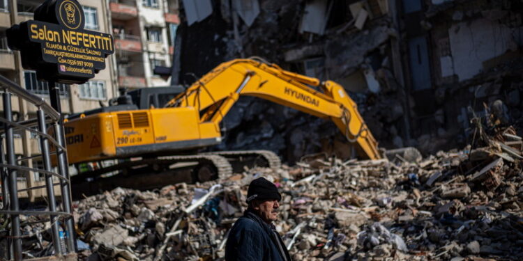 Mężczyzna stoi obok zawalonego budynku w następstwie potężnego trzęsienia ziemi w mieście Hatay, Turcja / Fot. EPA/MARTIN DIVISEK. Dostawca: PAP/EPA