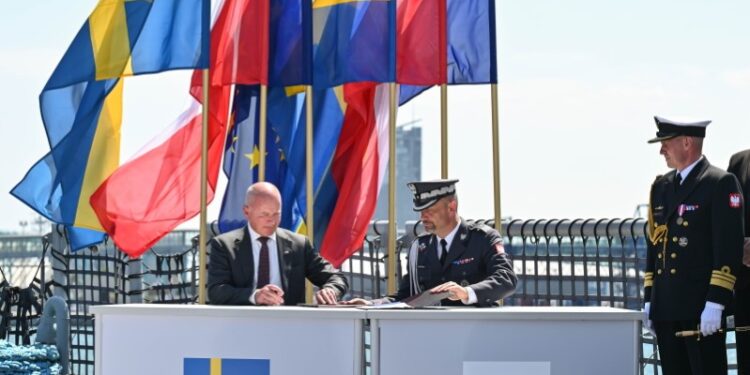 29.06.2026. Gdynia. Zastępca Szefa Agencji Uzbrojenia gen. bryg. Michał Marciniak (C) oraz prezes i dyrektor generalny SAAB Micael Johansson (L) podczas podpisania umowy na zakup trzech okrętów podwodnych A26 dla Marynarki Wojennej RP w ramach programu Orka, 29 bm. / Fot. PAP/Marcin Gadomski